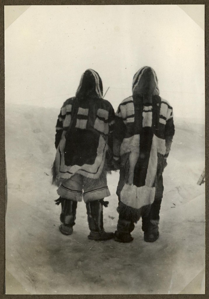 A meeting between a Netsilik Inuit man (left) and a Caribou Inuit man (right) at Baker Lake Canada. Botha re wearing clothing and boots made of caribou skin. Both parkas have fringes at the lower hem to prevent snow and cold to seep in under the garment. The Netsilik Inuit was wearing typical short flared trousers. Brown, black and white caribou skin was combined to create beautiful patterns. But the patterns were not only just for show. Even at long distance the patterns revealed the social identity of the wearer. Photograph from the 5th Thule-expedition 1921-24.